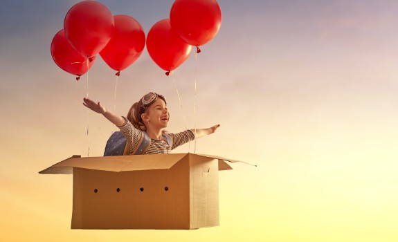 Girl flying with balloons