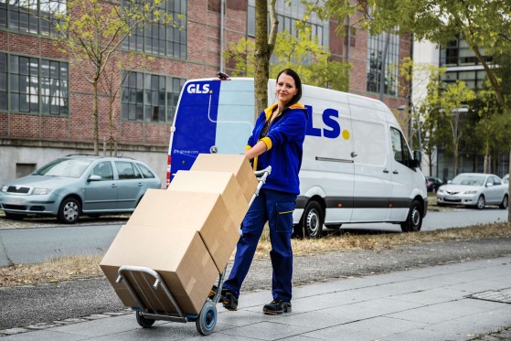 Woman driver delivering parcels in a city setting.