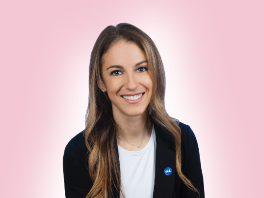 Professionally dressed woman smiling.