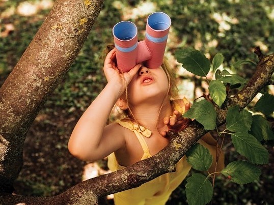 Girl looking through self-made binoculars
