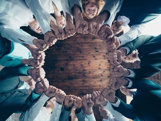 People form a circle with their hands