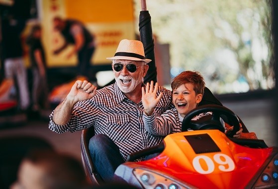 Grandpa and grandson in an auto scooter