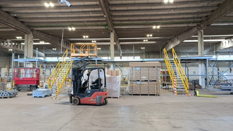 Interior of a logistics warehouse with a forklift and goods sorting area