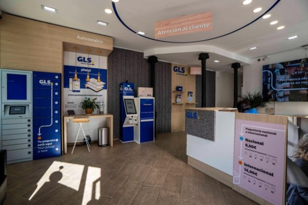 Interior of a GLS point with automated lockers and a customer service desk for e-commerce parcel drop-off and pickup