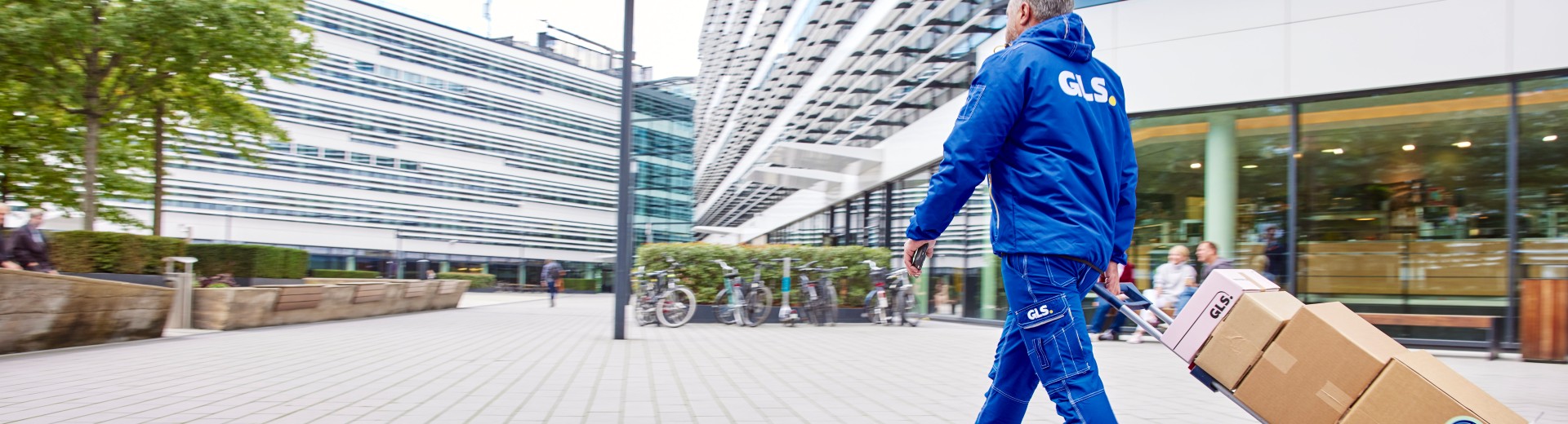 A GLS driver delivers parcels in the city