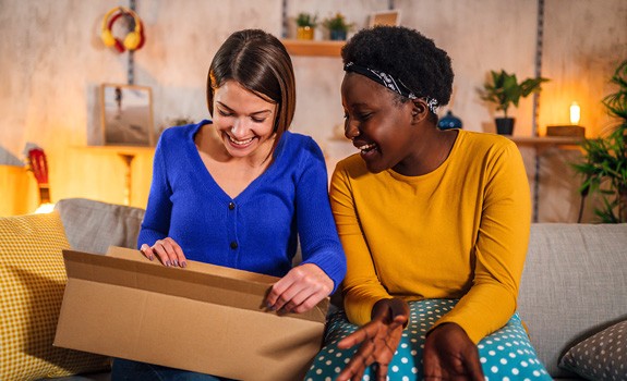 smiling consignee opens her parcel