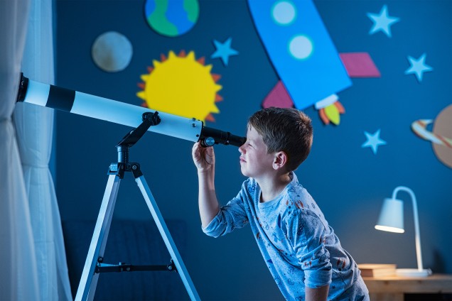 child looking at the future with the telescope