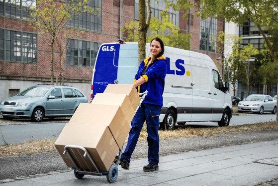 GLS courier loads the parcels into his van from a ParcelShop