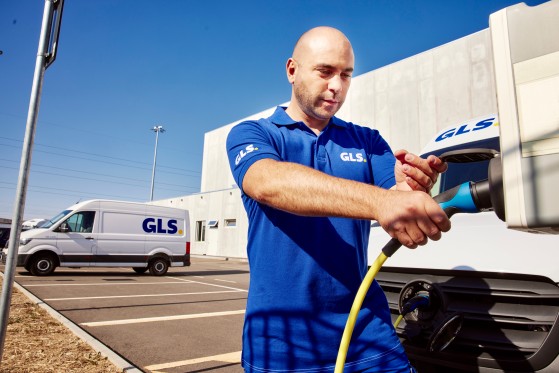 GLS employee charging an electric GLS van