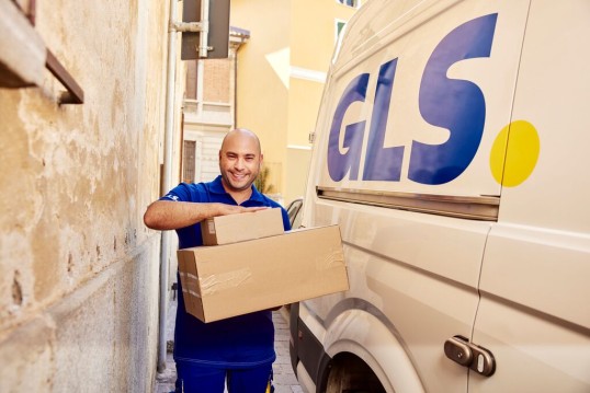 GLS delivery driver with parcel and GLS delivery van 