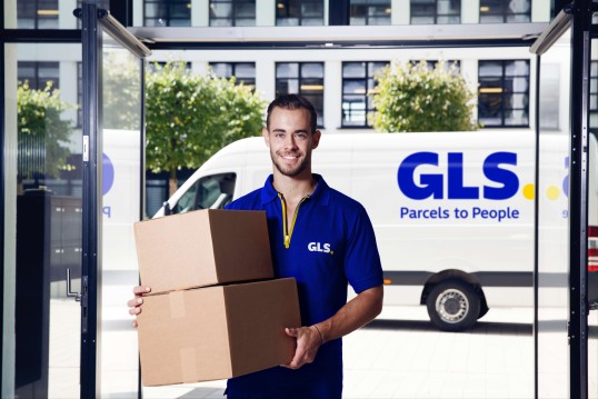 Gls delivery man delivers a parcel to recipient