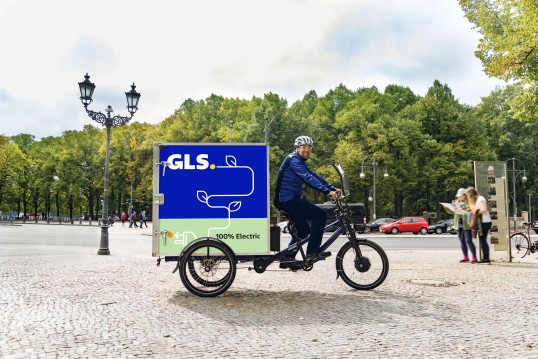 GLS eco courier bike delivering packages to recipients