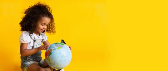 Girl is playing with the globe