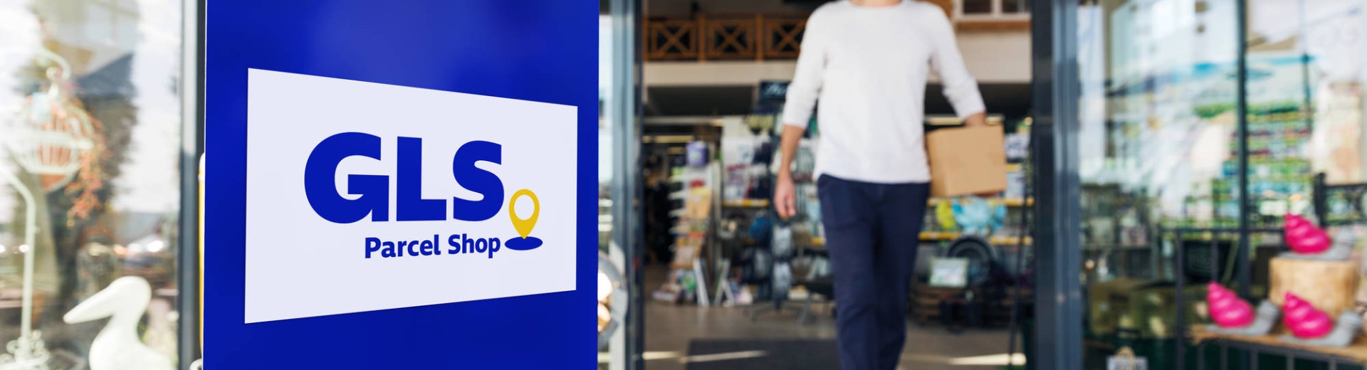 Man coming out from a GLS parcel shop