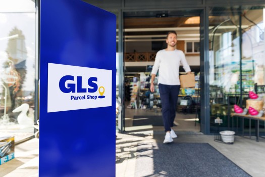 Man coming out from a GLS parcel shop