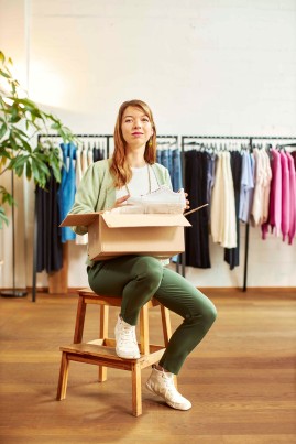 Woman sitting on a chair with a parcel
