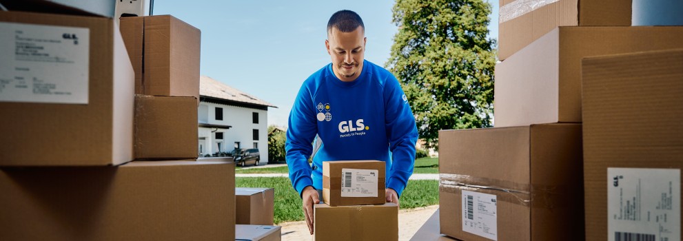 A GLS couruer with parcels in van